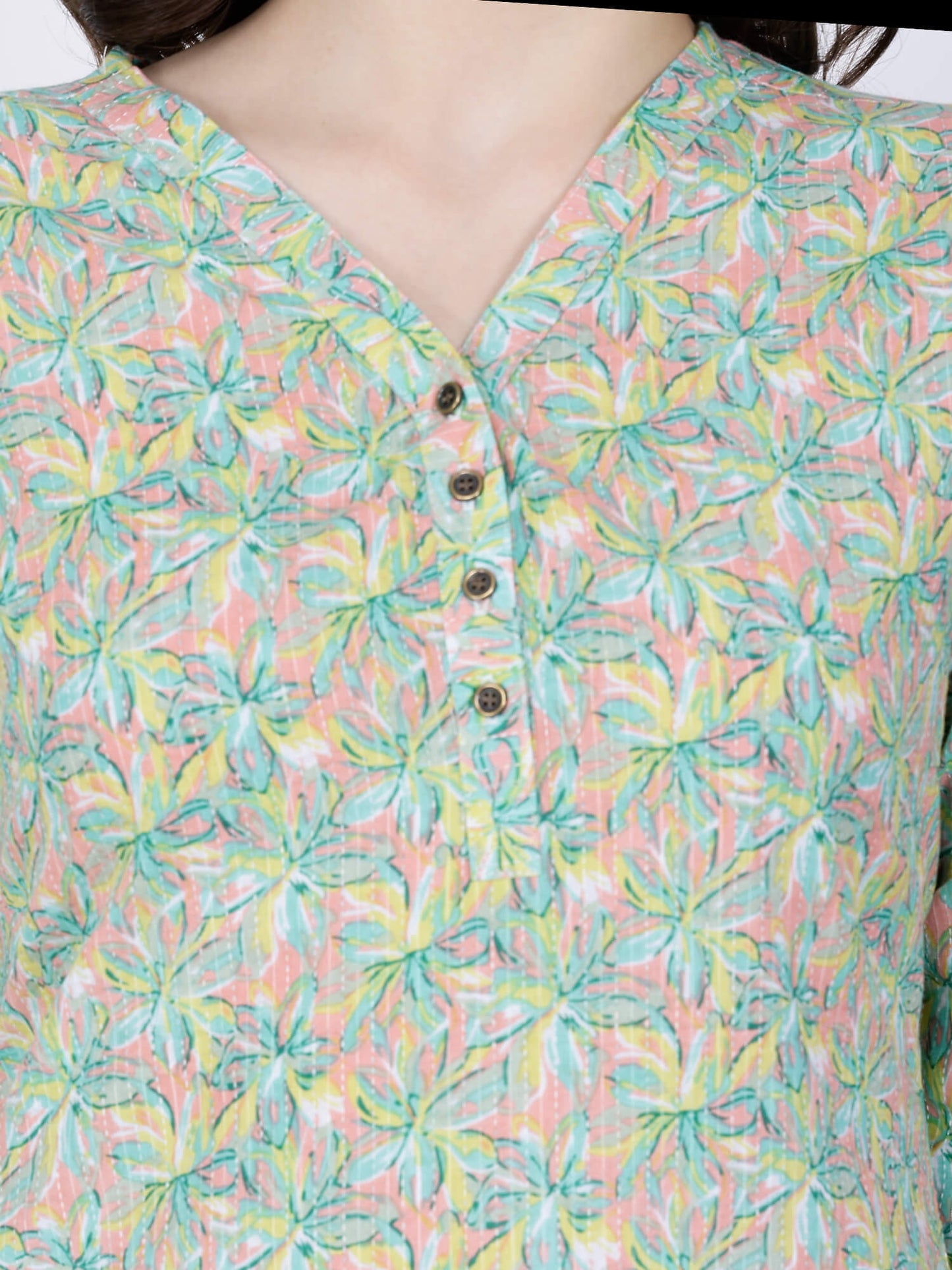 Close-up of V-neck with brass buttons on cotton kurti
