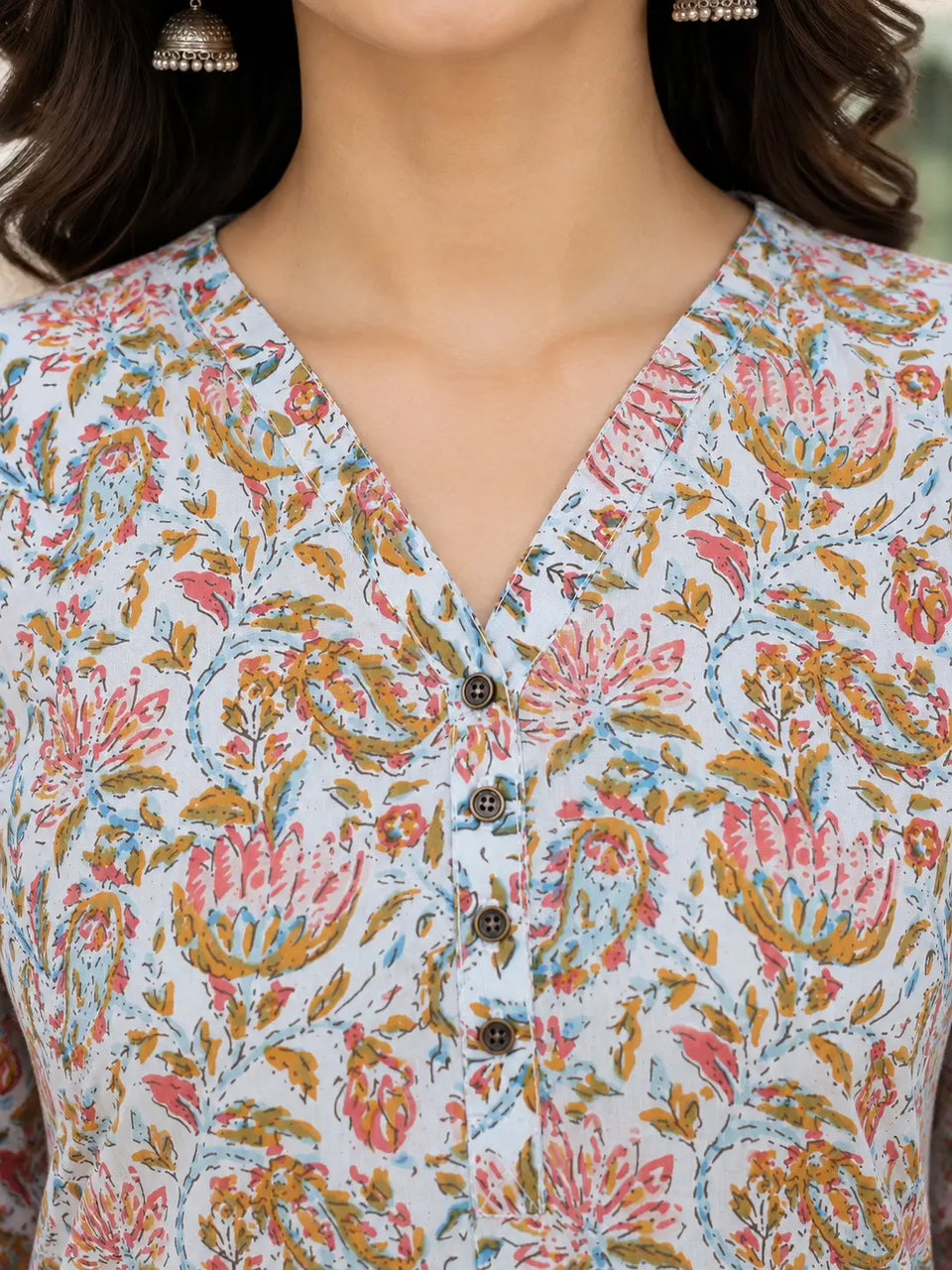 Closeup of Rabric light blue floral cotton V neck top with button detailing for women casual ethnic wear