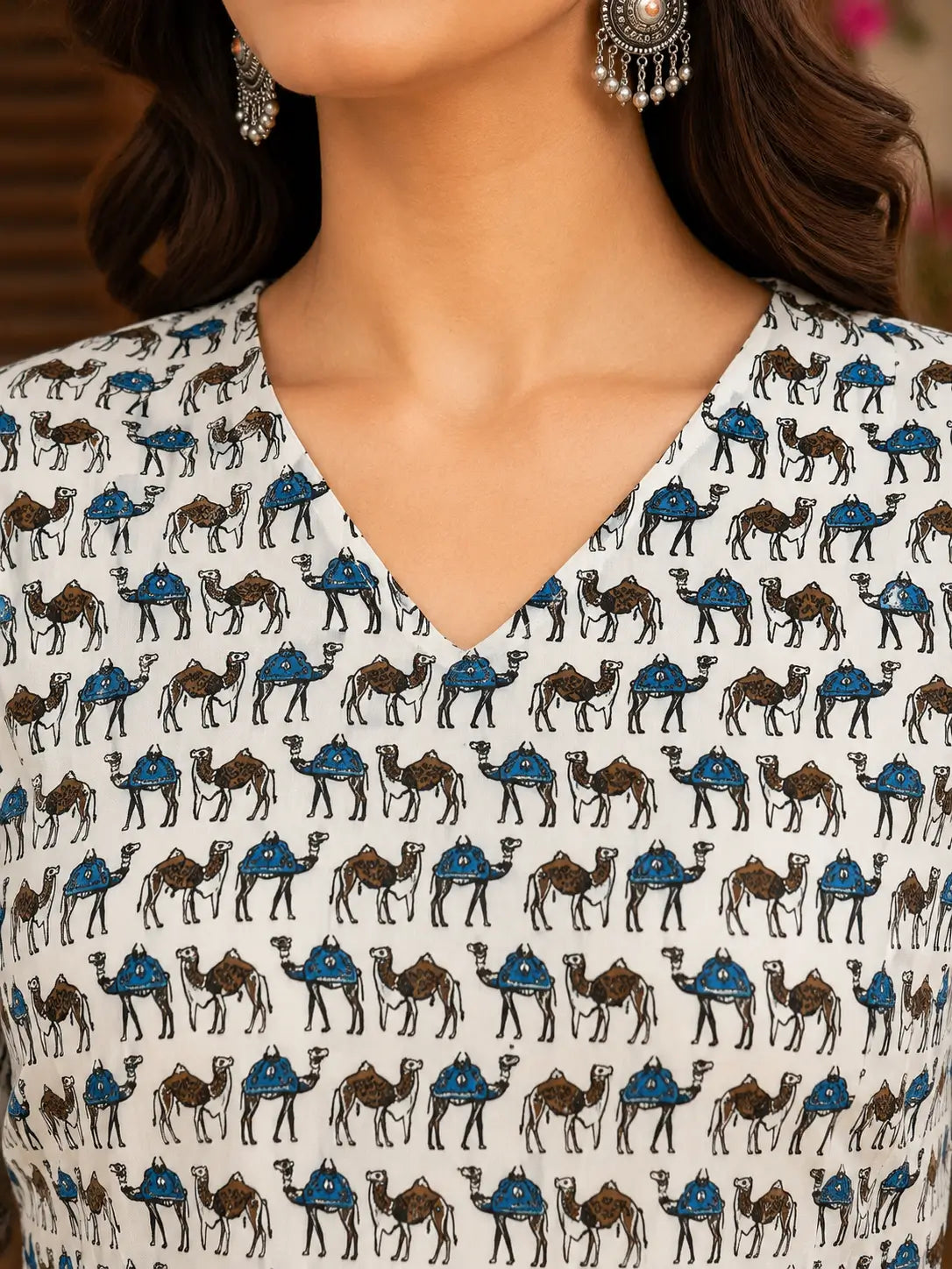 Closeup of V neck design on Rabric ivory cotton camel print women short top with soft breathable fabric