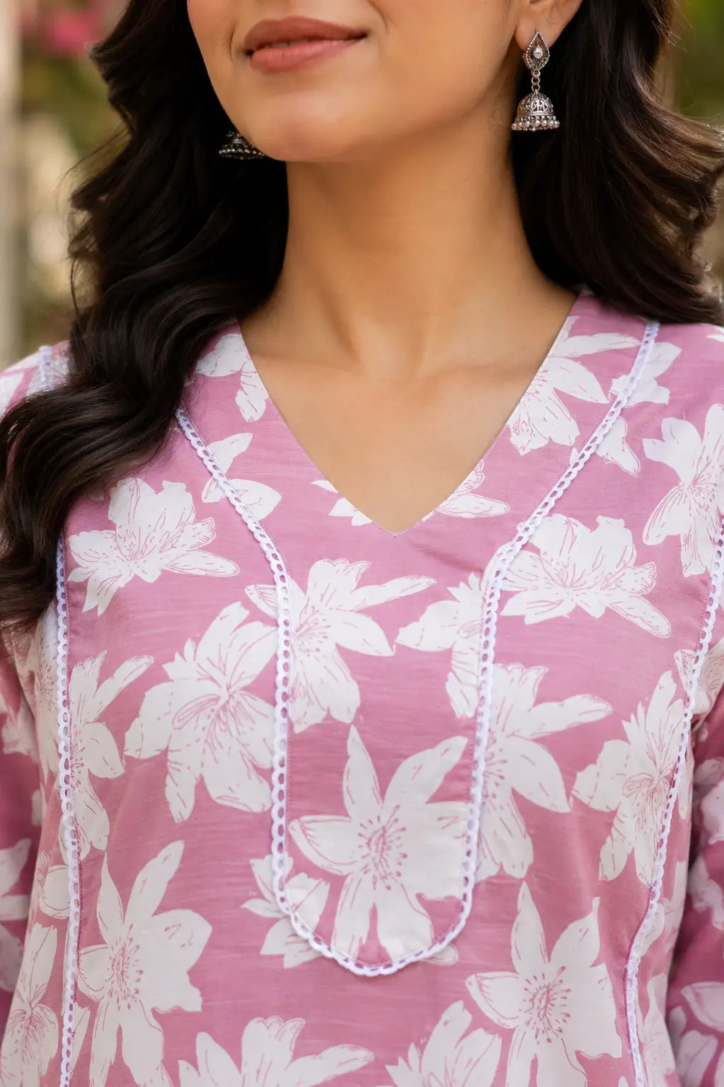Close up of stylish V neck design on Rabric pink floral cotton kurti for women with elegant detailing