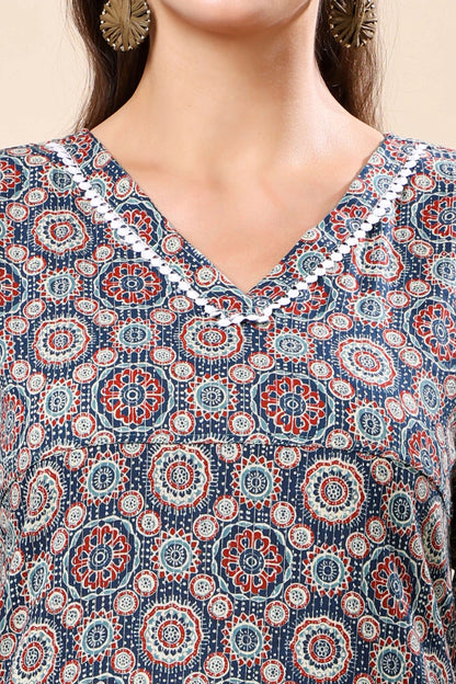 Close-up of geometric mandala print and lace detailing on V-neck kurti