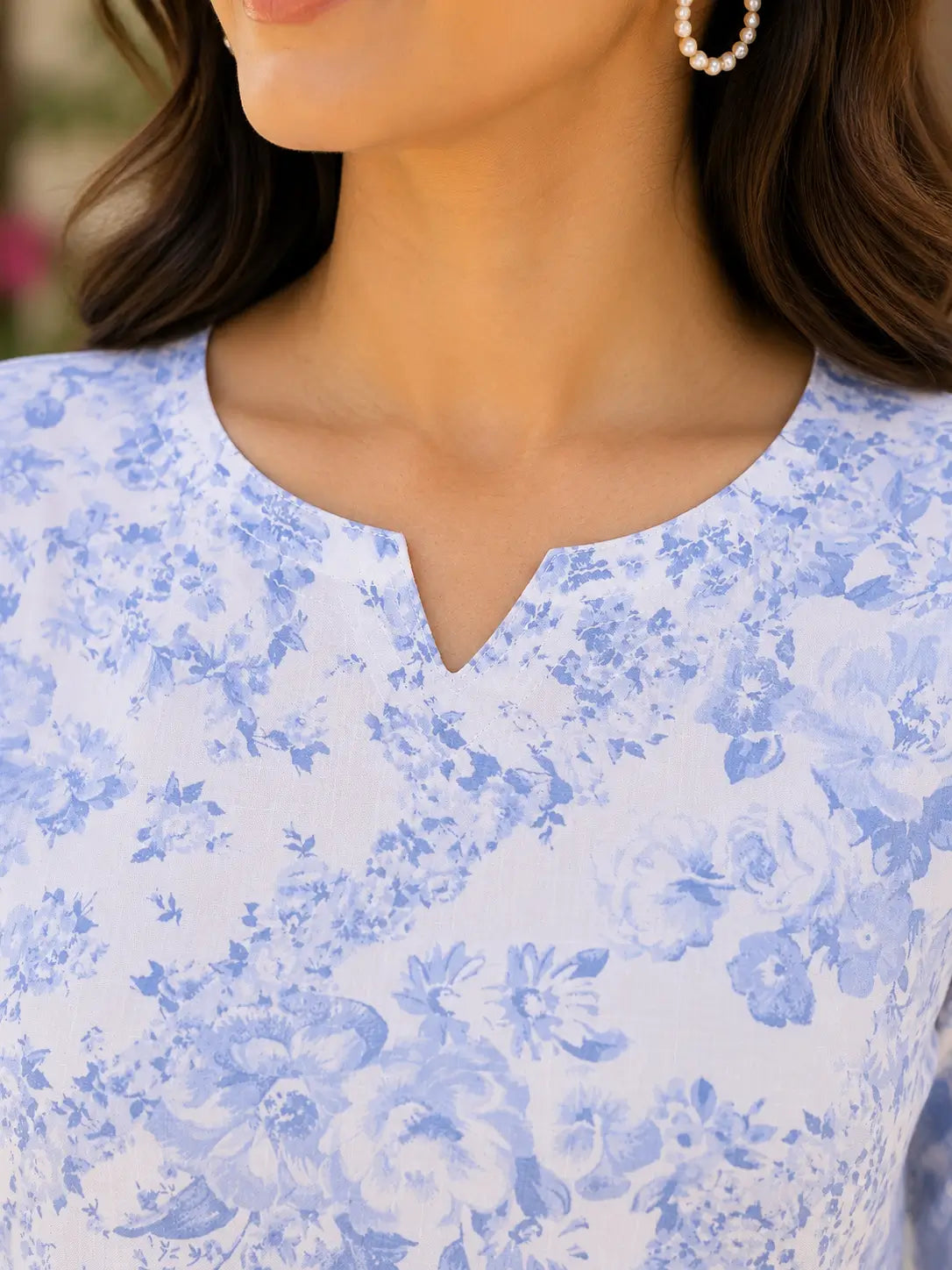 Closeup of V neck design on Rabric white blue floral cotton short top for women with soft rayon feel fabric
