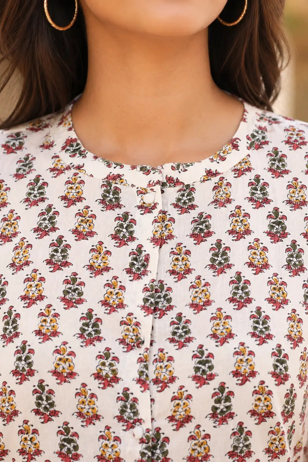 Closeup of round neck design on Rabric white floral cotton short top with front button placket detail