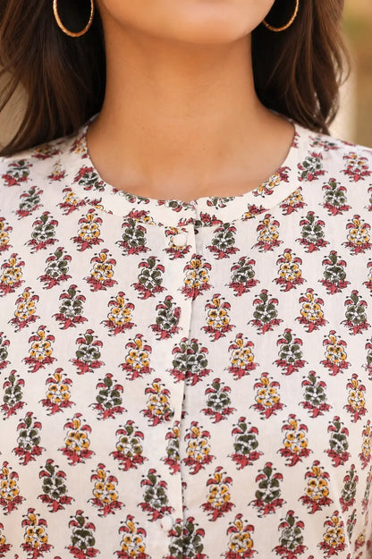 Closeup of round neck design on Rabric white floral cotton short top with front button placket detail