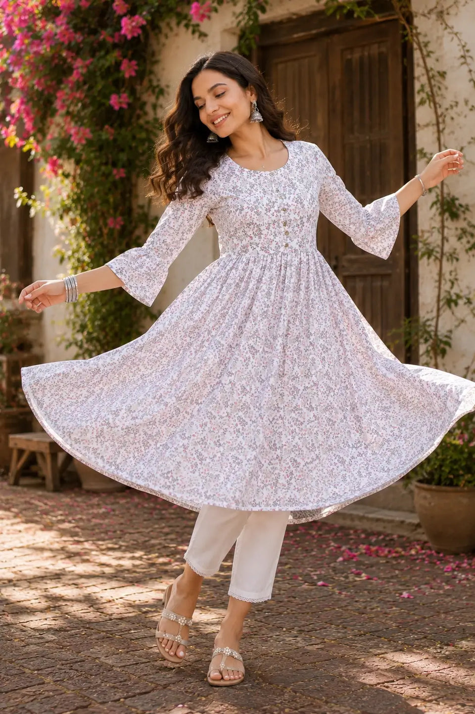 Flared white floral crepe women kurti by Rabric shown in dancing pose highlighting full flair design