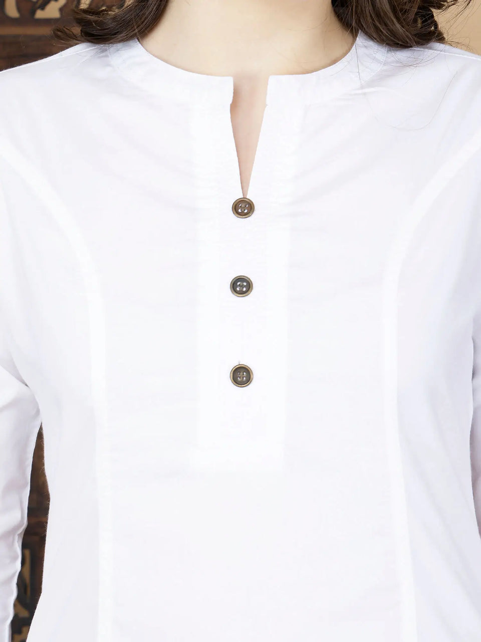 Close-up of brass buttons and thread design on Rabric white kurti neckline