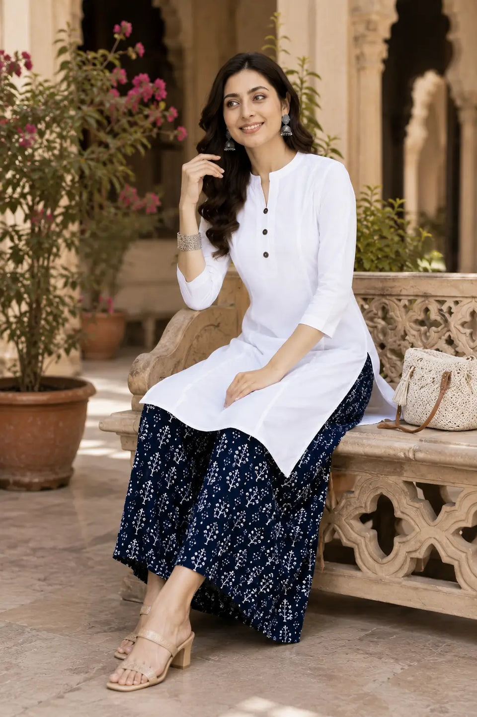 Elegant sitting pose lifestyle image of white popline cotton women kurti with casual accessories by Rabric