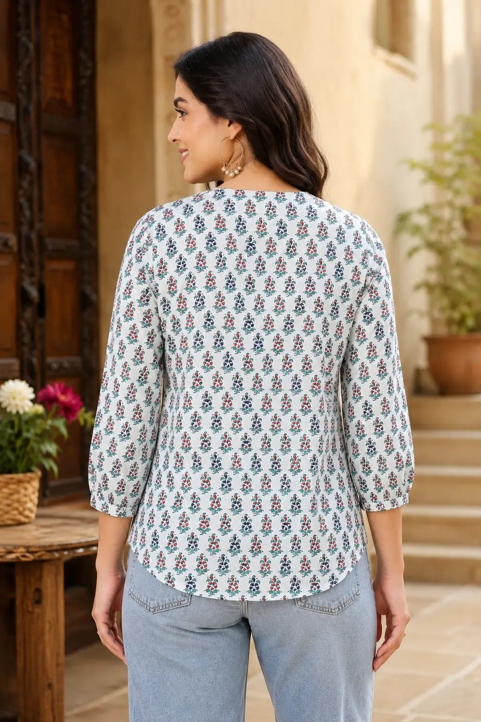 Back view of Rabric white floral printed cotton short top for women with 3/4 elastic sleeves and curved hem design