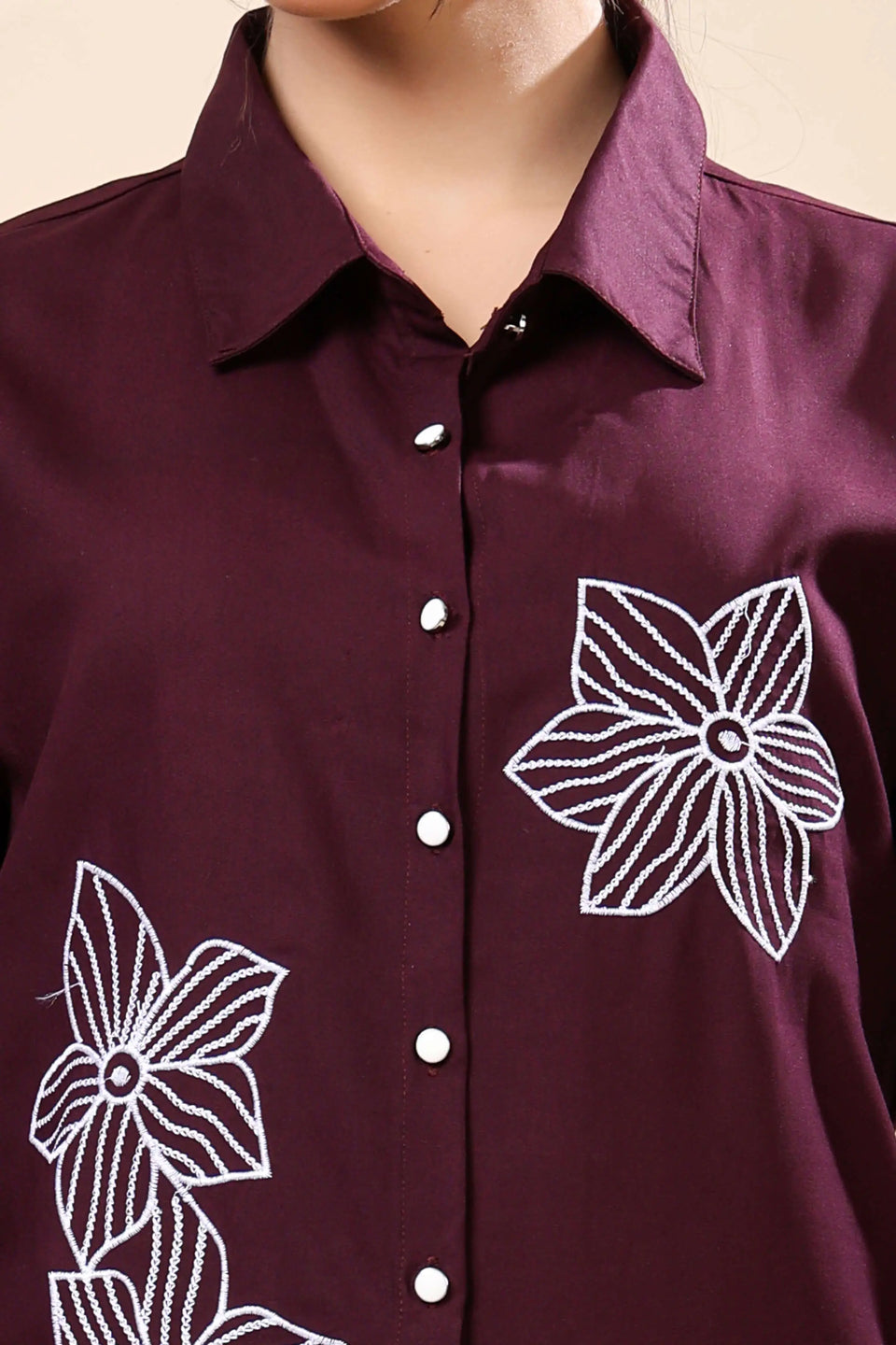 Close-up of white floral embroidery on Rabric wine co-ord set top and trouser