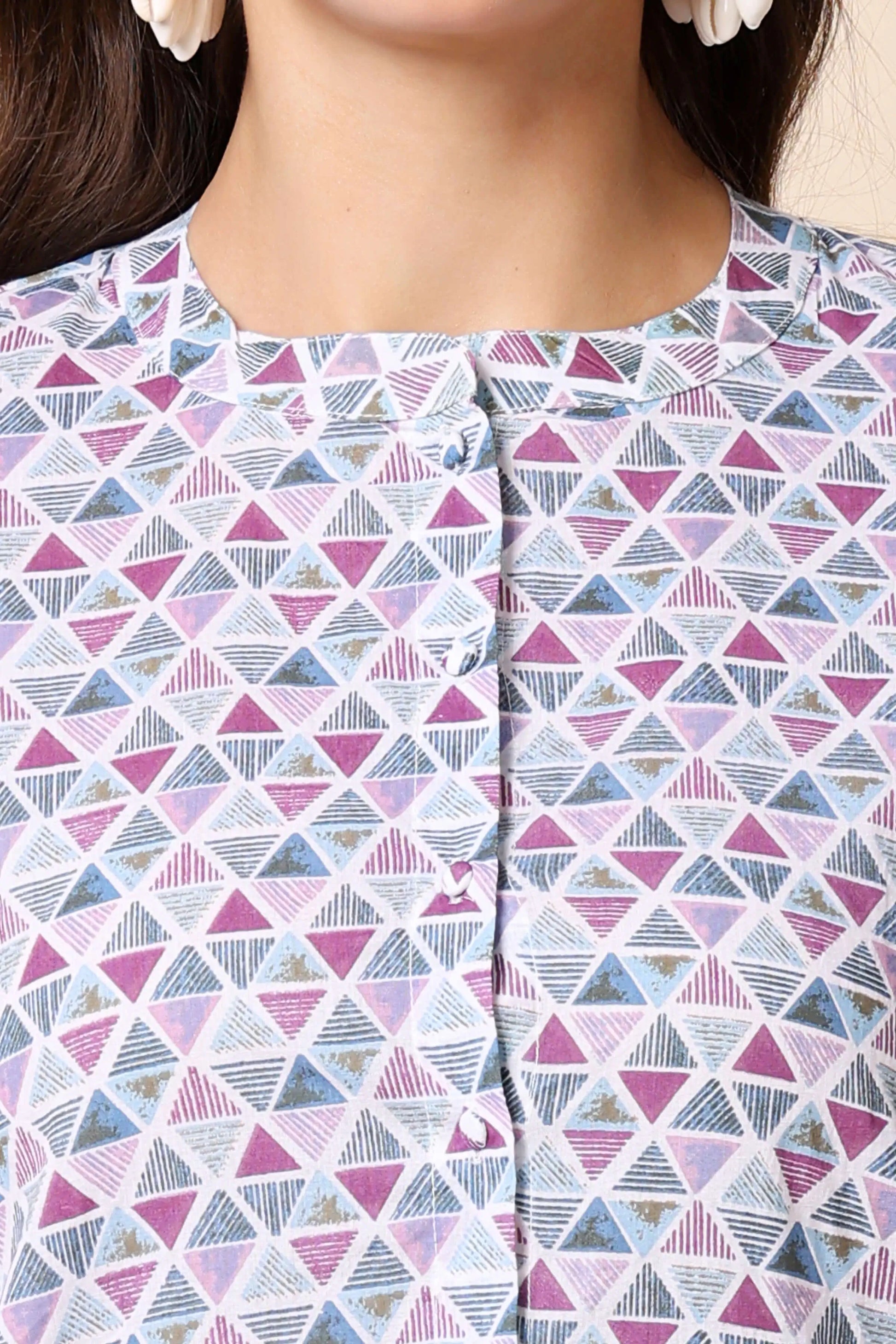 Closeup of cotton fabric and buttons on women’s shirt top