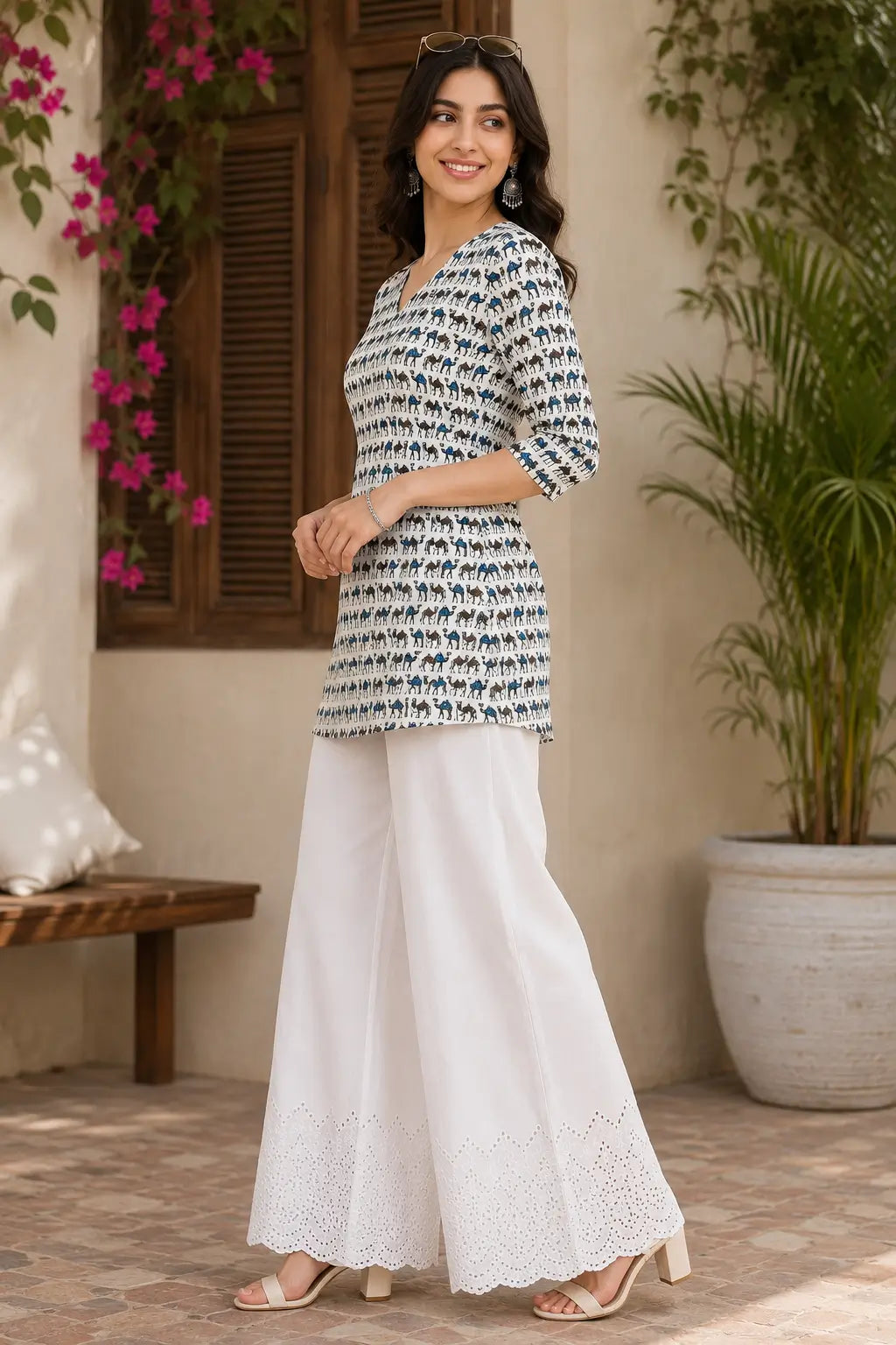 Side angle view of Rabric women ivory cotton camel print casual short top paired with white palazzo pants
