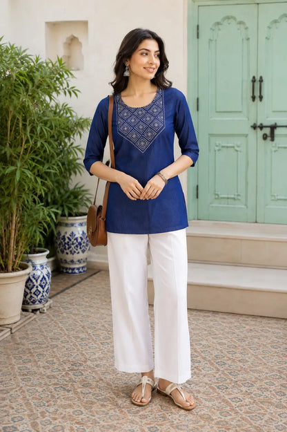 Woman wearing Rabric navy blue cotton embroidered short top with white pants casual lifestyle fashion look