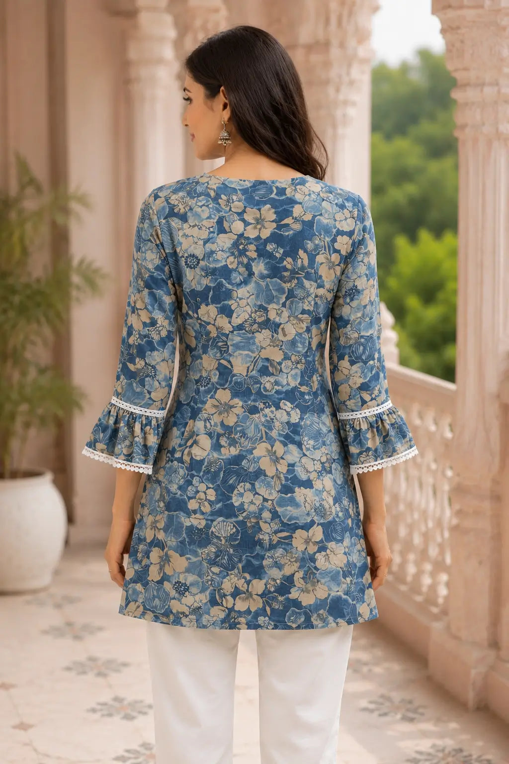 Back view of women’s blue floral cotton short top with layered bell sleeves and straight fit design