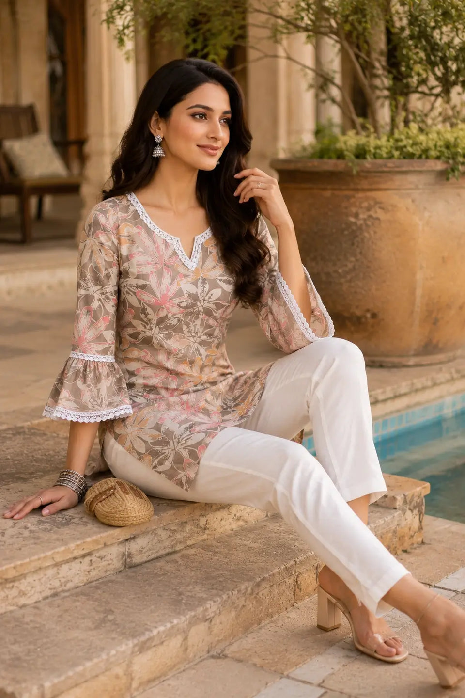 Women cotton floral short top in relaxed sitting pose with casual accessories and ethnic fashion styling