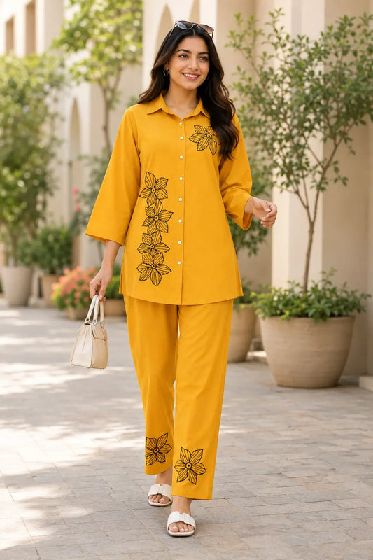 Rabric mustard yellow rayon floral print co-ord set for women with collared short shirt, 3/4 sleeves, black floral embroidery print and straight fit pants front view
