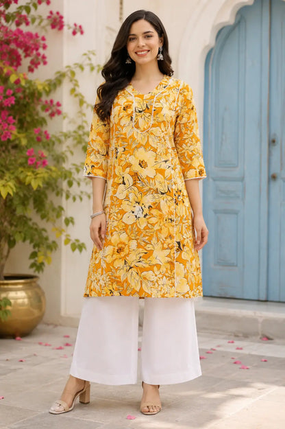 Rabric yellow floral cotton kurti for women front view with stylish neck design, mid length kurta, 3/4 sleeves and white palazzo pants