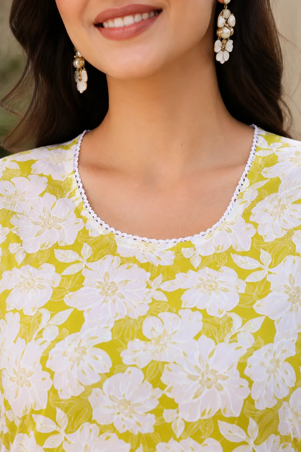 Close up of stylish round neck design on yellow and white floral cotton kurti by Rabric for women
